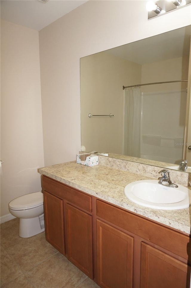 bathroom featuring tile patterned floors, toilet, and vanity