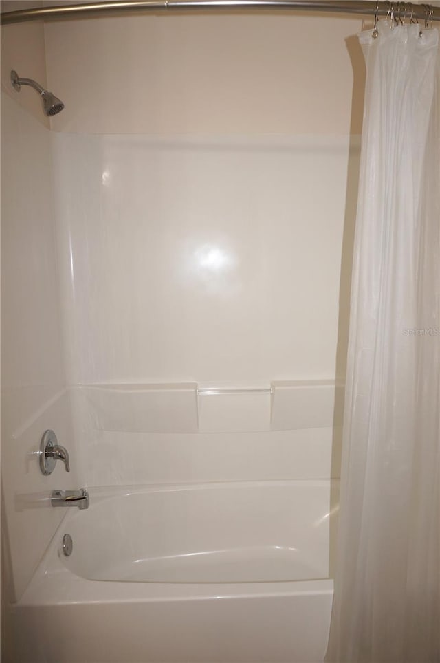 bathroom featuring shower / tub combo with curtain