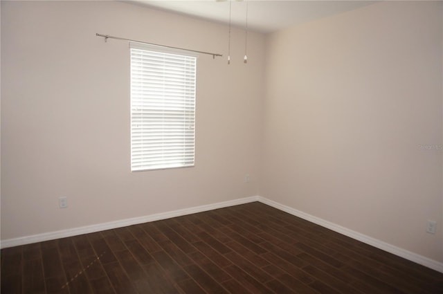 unfurnished room featuring dark hardwood / wood-style flooring