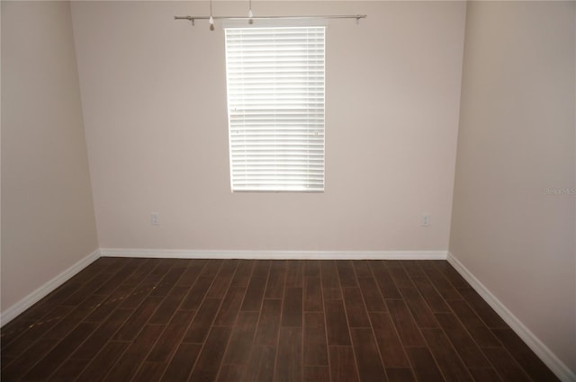 unfurnished room featuring dark wood-type flooring