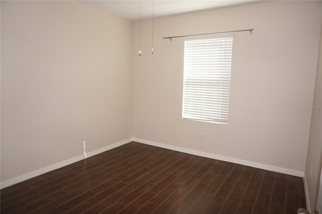 spare room with dark hardwood / wood-style flooring