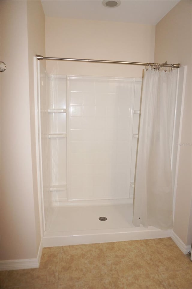 bathroom featuring tile patterned floors and a shower with curtain