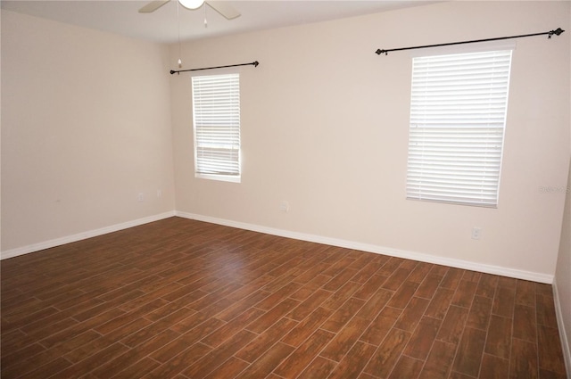 unfurnished room with ceiling fan and dark wood-type flooring