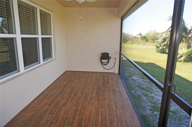 unfurnished sunroom featuring ceiling fan