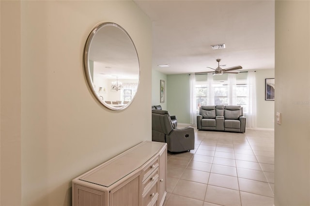 27261 Guapore Dr, Punta Gorda, FL 33983 - corridor with light tile patterned floors, a chandelier, and baseboards