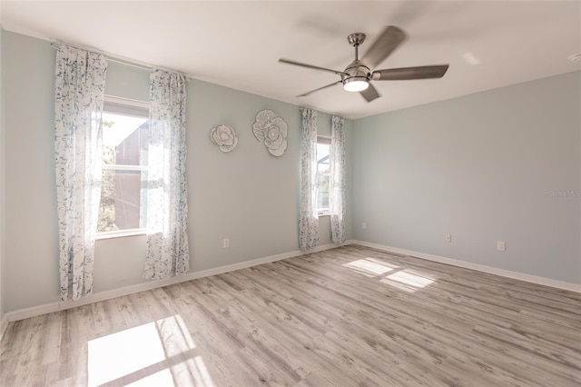 27261 Guapore Dr, Punta Gorda, FL 33983 - unfurnished room featuring plenty of natural light, wood finished floors, ceiling fan, and baseboards