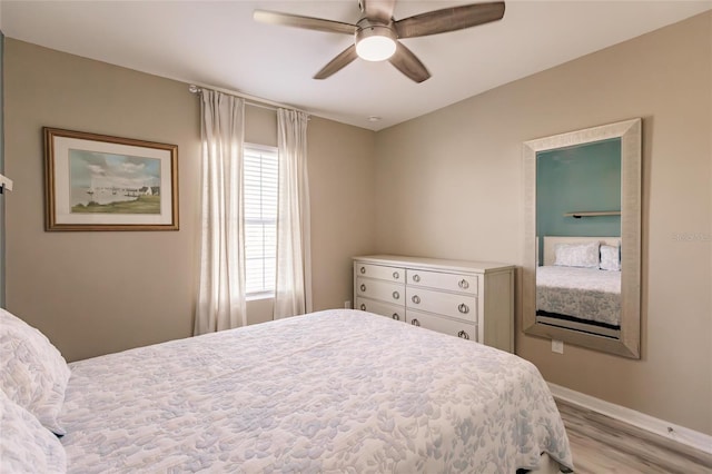 bedroom with ceiling fan and light hardwood / wood-style flooring