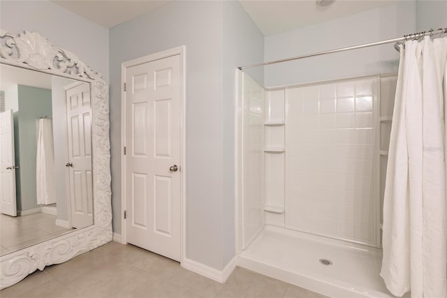 bathroom with tile patterned floors and curtained shower