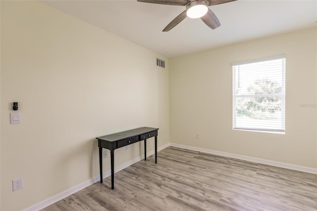 empty room with light wood-type flooring and ceiling fan