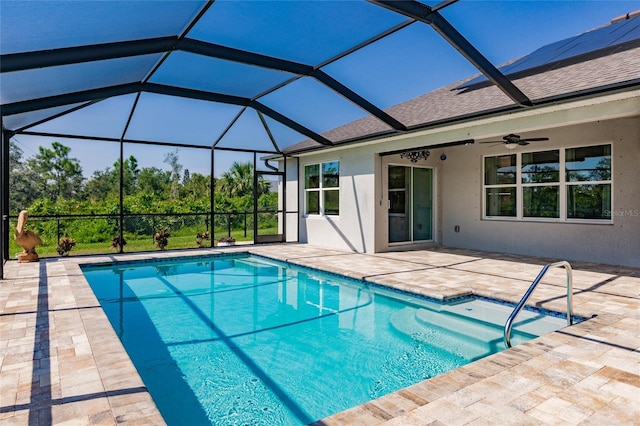 view of pool with ceiling fan, a patio area, and a lanai