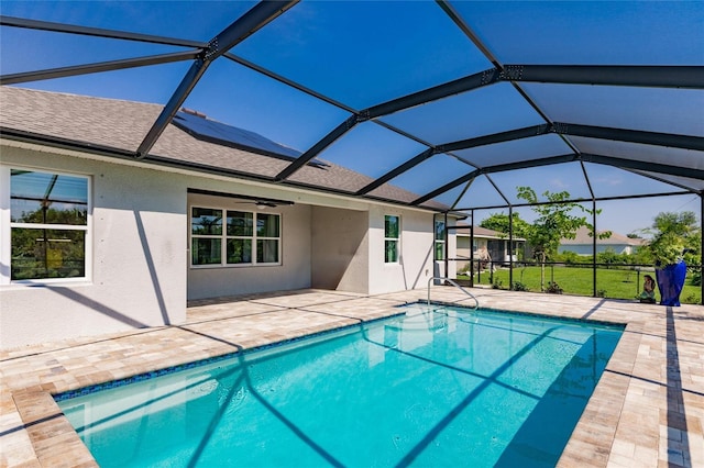 view of pool featuring glass enclosure and a patio area