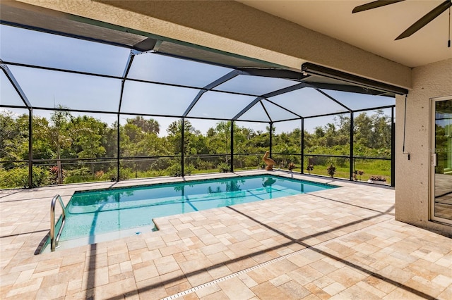 view of swimming pool with ceiling fan, a patio, and a lanai