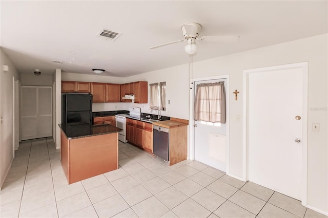 kitchen with light tile patterned floors, white electric range oven, black refrigerator, dishwasher, and ceiling fan