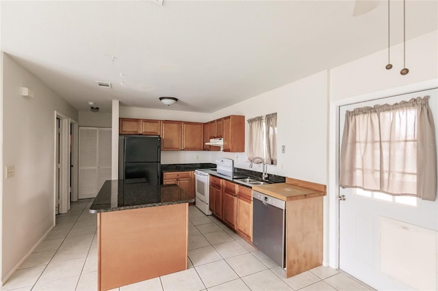 kitchen with stainless steel dishwasher, electric range, light tile patterned floors, a center island, and black refrigerator