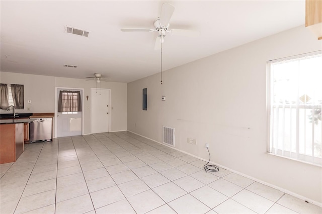 unfurnished living room featuring ceiling fan, light tile patterned floors, and sink