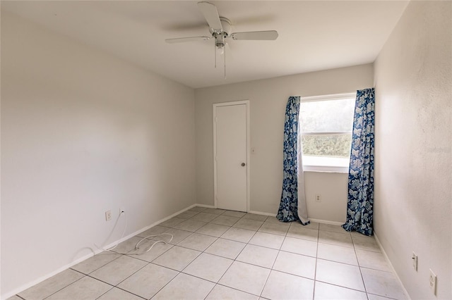 tiled empty room with ceiling fan