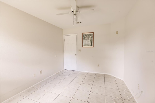 tiled spare room with ceiling fan