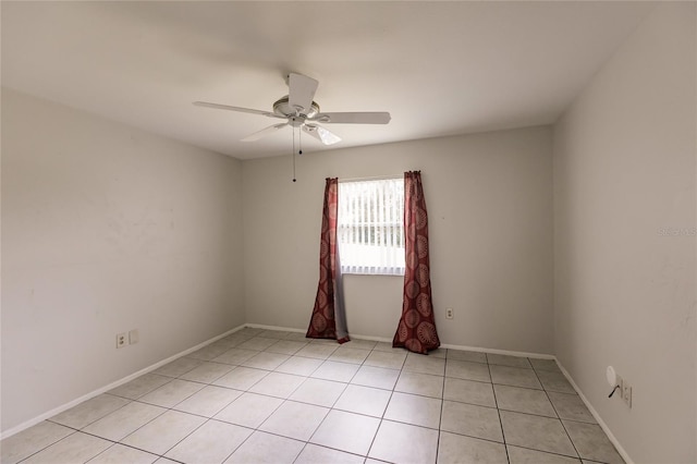 spare room with ceiling fan and light tile patterned floors