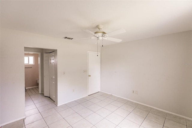 unfurnished room with light tile patterned floors and ceiling fan