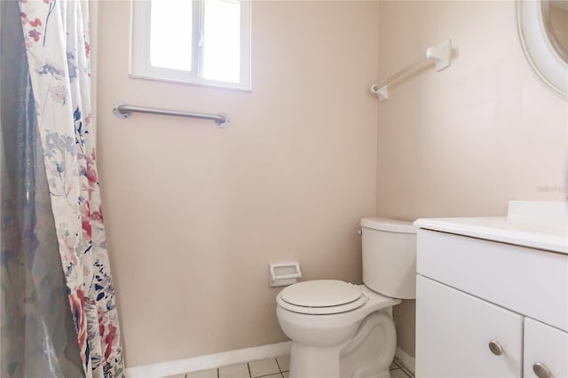 bathroom featuring tile patterned flooring, vanity, and toilet