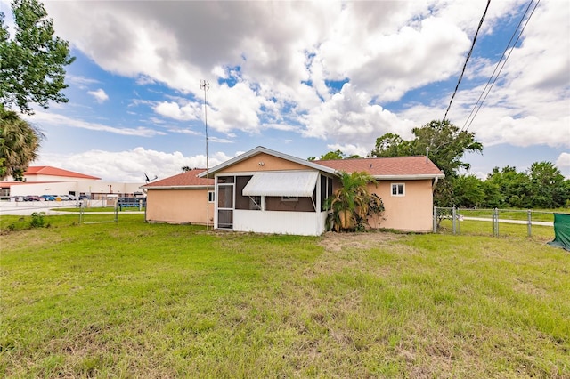 rear view of property with a lawn