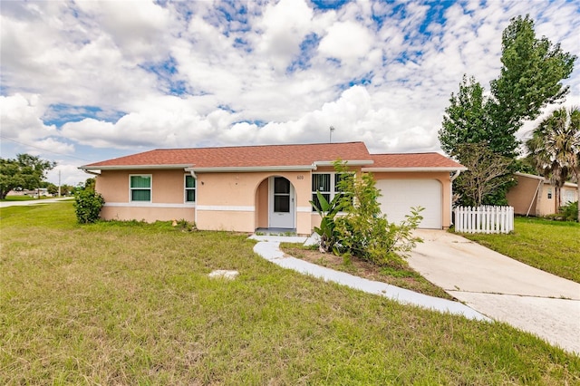 single story home with a garage and a front yard