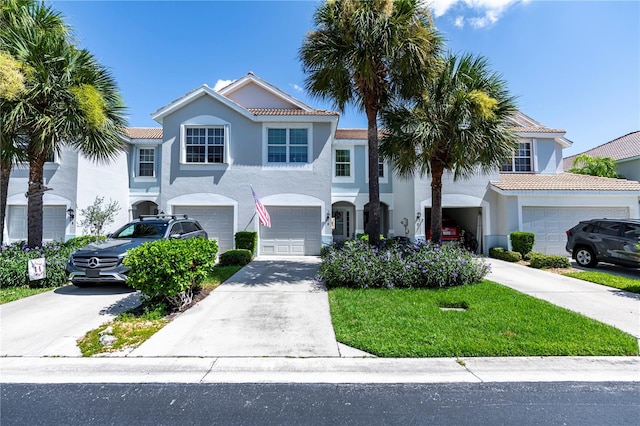 mediterranean / spanish-style house with stucco siding, driveway, and a garage