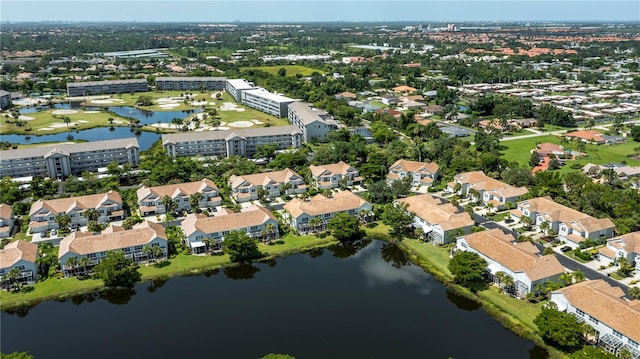 drone / aerial view with a residential view and a water view