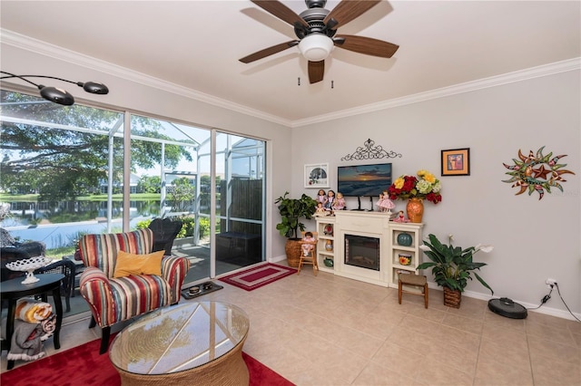 tiled living room featuring a glass covered fireplace, ornamental molding, baseboards, and a sunroom