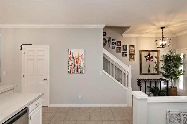 interior space with light tile patterned flooring, stainless steel dishwasher, decorative light fixtures, and white cabinets