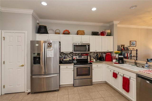 kitchen featuring a sink, backsplash, stainless steel appliances, light tile patterned flooring, and white cabinets