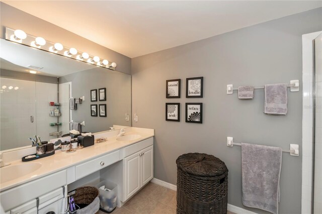 bathroom with double vanity and tile patterned floors