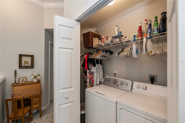 laundry area with washer and dryer, laundry area, crown molding, and light carpet