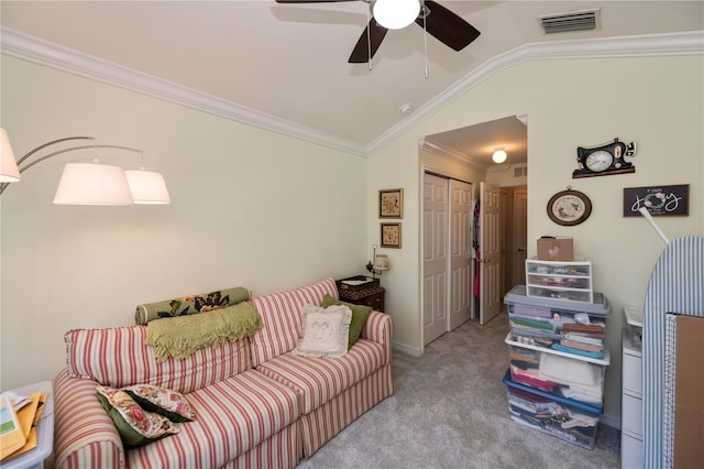 living area with visible vents, ornamental molding, carpet flooring, ceiling fan, and vaulted ceiling