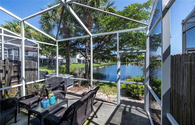 unfurnished sunroom featuring a water view