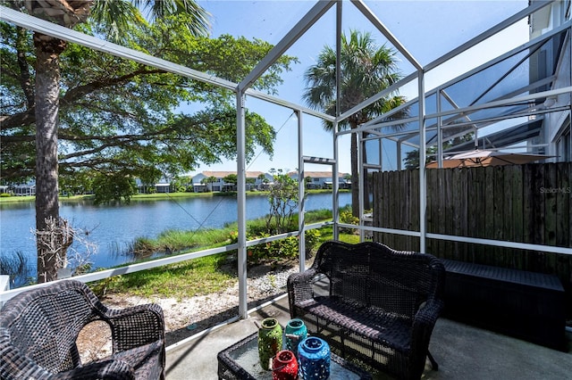 sunroom / solarium featuring a water view