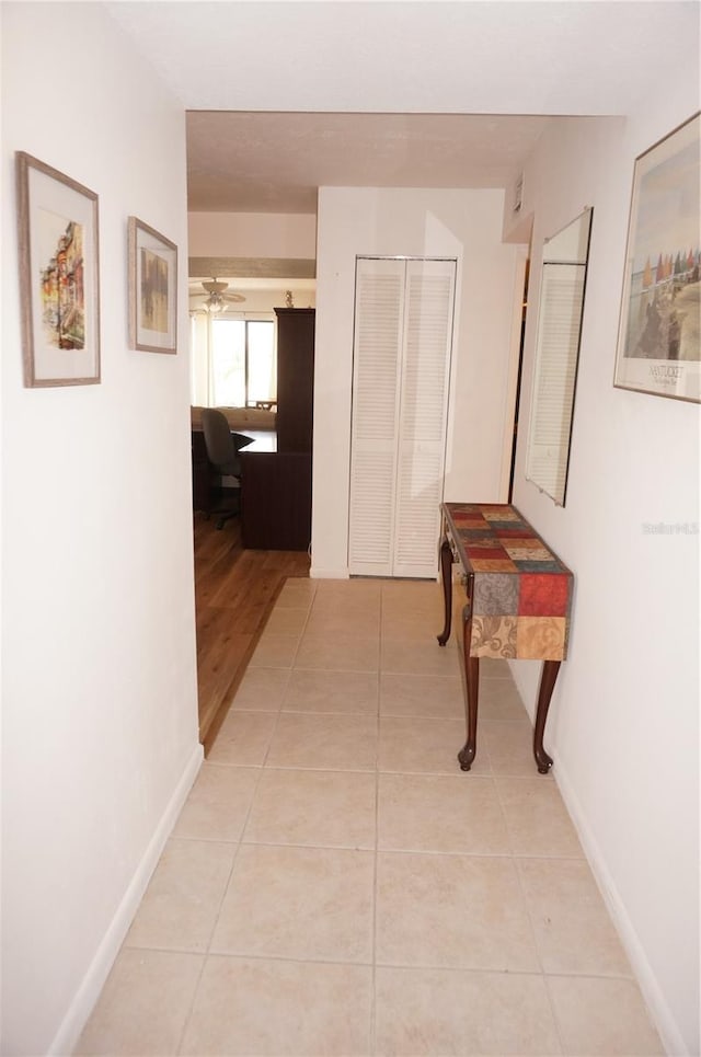 hallway featuring light tile patterned flooring