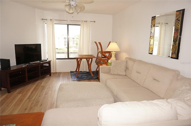 living room featuring light hardwood / wood-style flooring and ceiling fan