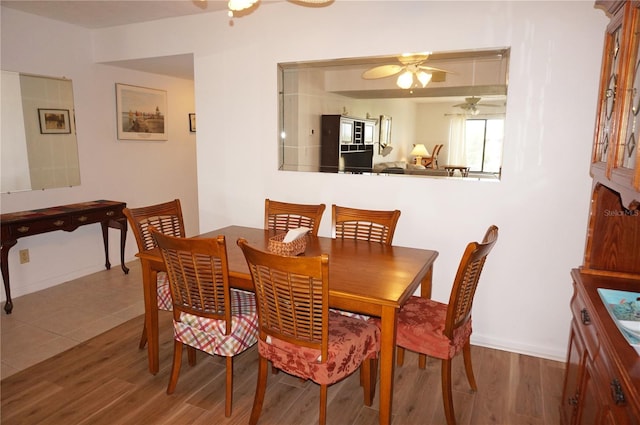 dining space featuring ceiling fan and wood-type flooring