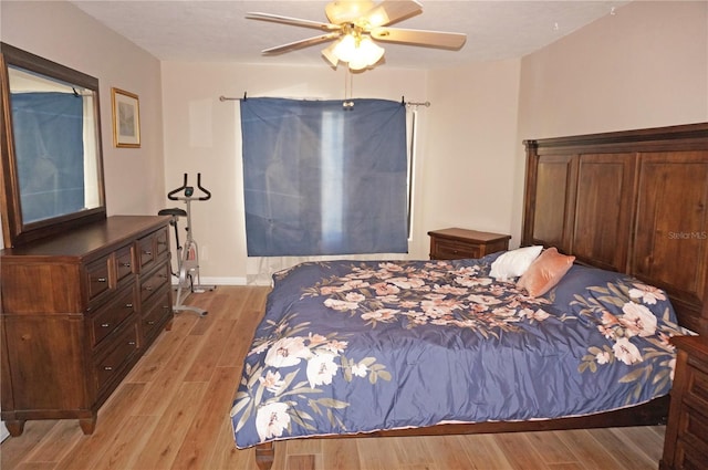 bedroom with ceiling fan and light hardwood / wood-style flooring