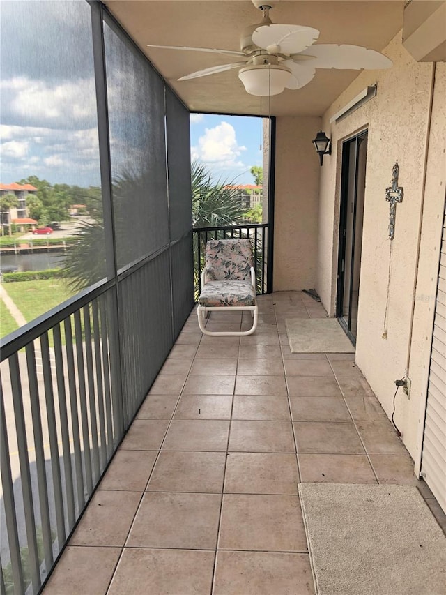 unfurnished sunroom featuring ceiling fan