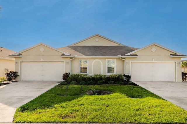 single story home featuring a front lawn and a garage