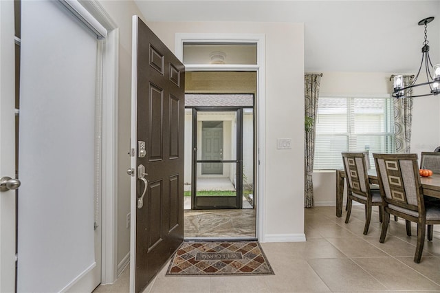 entrance foyer featuring a chandelier and light tile patterned floors