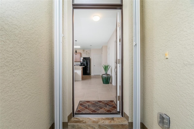 hallway with tile patterned flooring