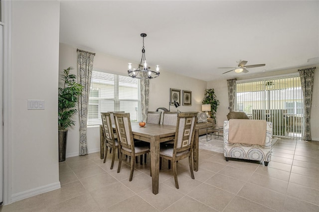 dining room featuring light tile patterned floors and ceiling fan with notable chandelier