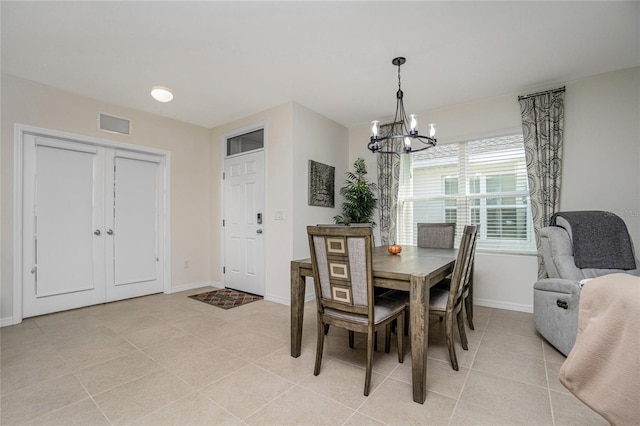 tiled dining area with a notable chandelier