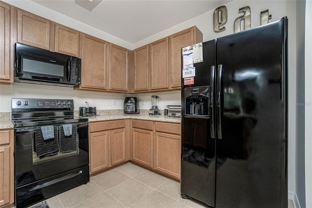 kitchen featuring light tile patterned floors and black appliances