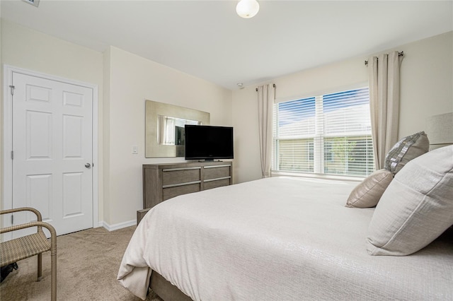 bedroom featuring light carpet