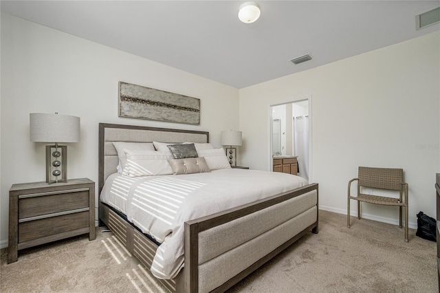 carpeted bedroom featuring ensuite bathroom