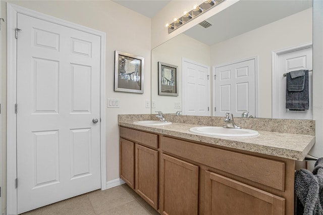 bathroom featuring tile patterned flooring and double vanity